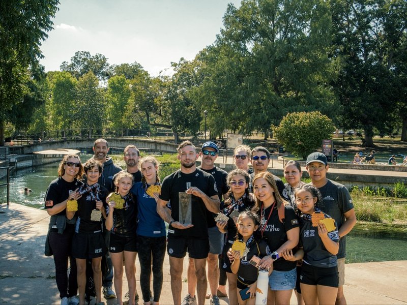 Labyrinth BJJ team group photo with medals and trophy