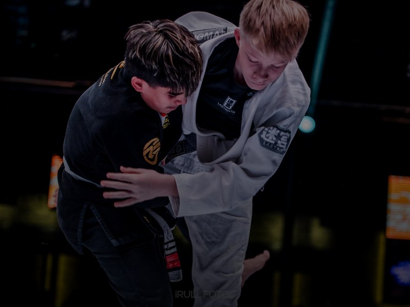 BJJ competitor celebrating victory on the podium