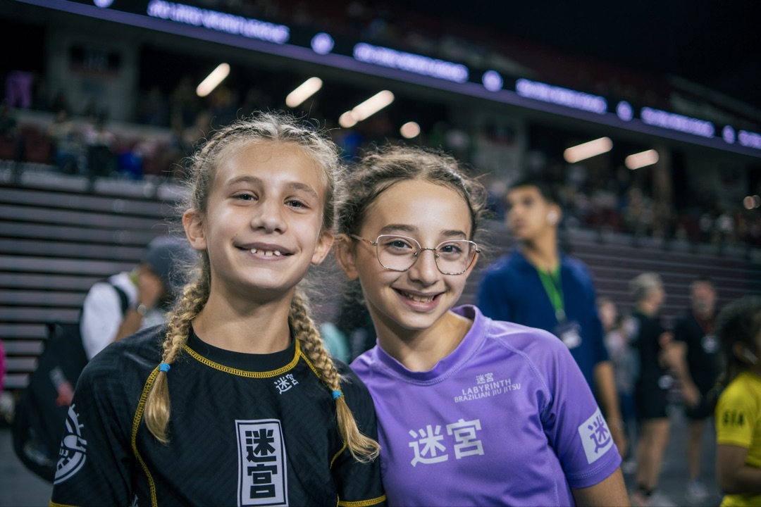 Four kids holding gold medals